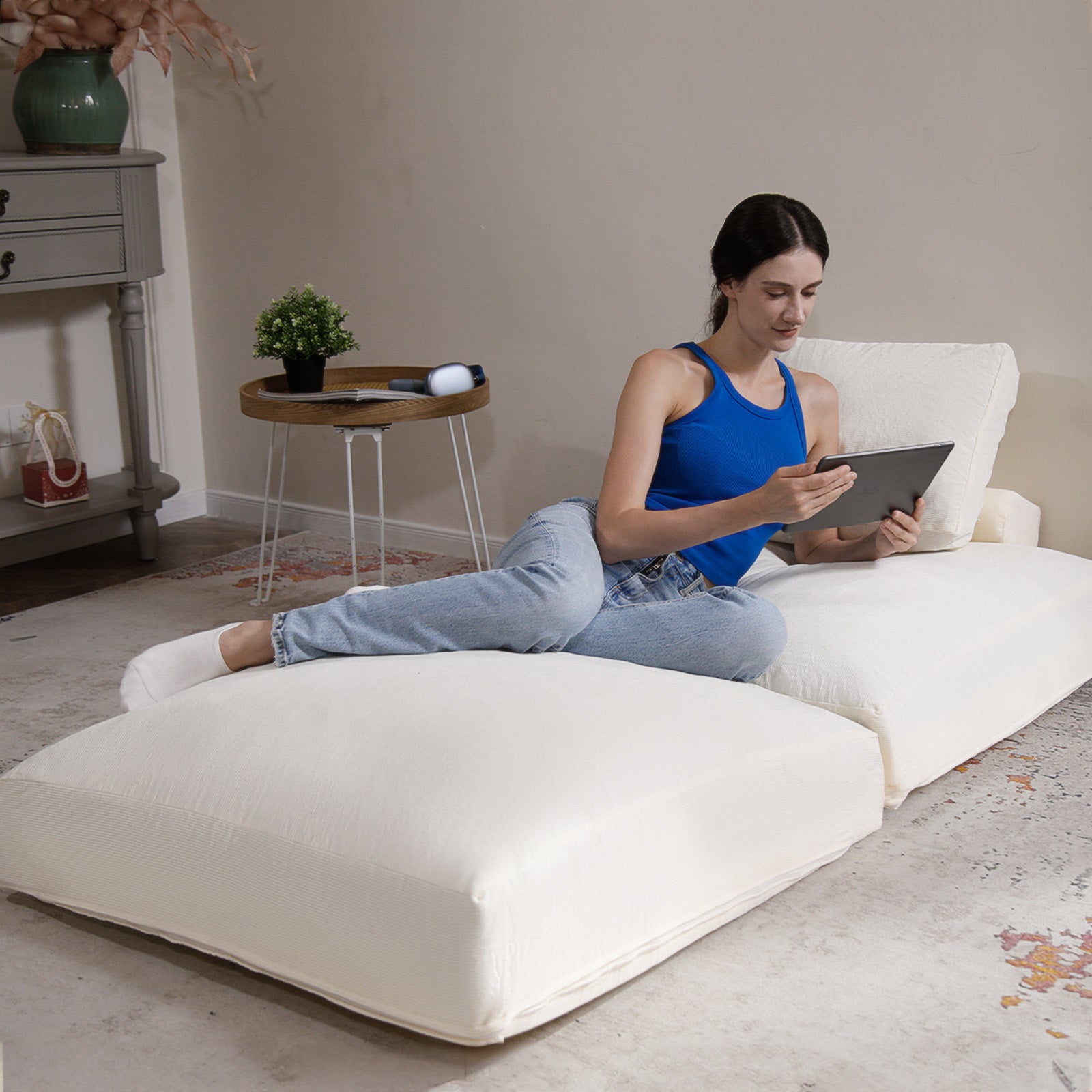 Lady reading a book on a Beige Folding Sofa Bed.