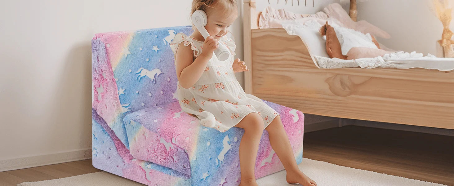 Girl sitting on Glowsofa's Children's Fold Out Sofa