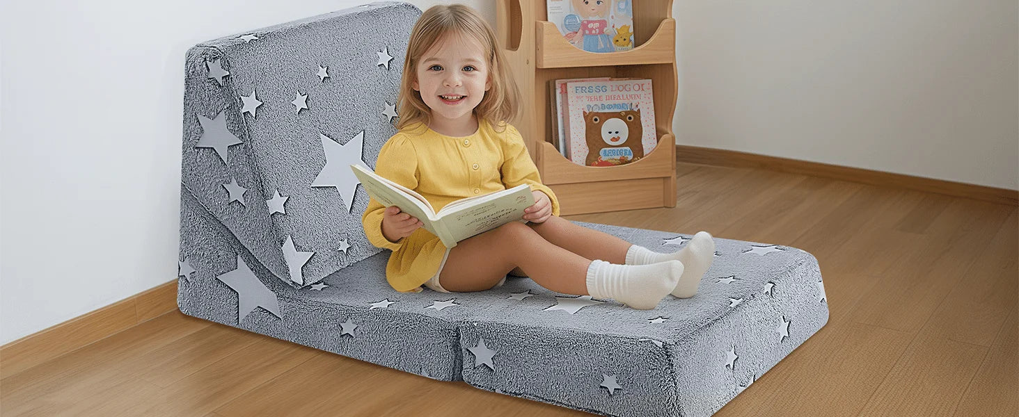 Girl sitting on Glowsofa's Children's Fold Out Sofa reading book